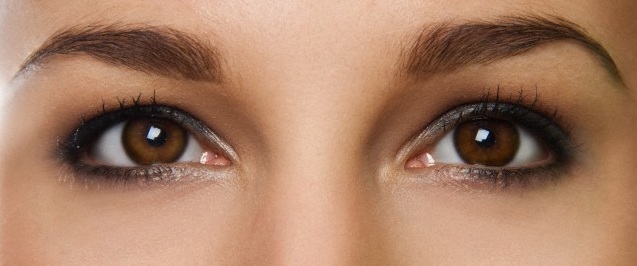 Cropped studio portrait of young woman's eyes