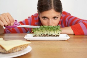 Woman Trimming Sprouts on Plate --- Image by © Kate Mitchell/Corbis