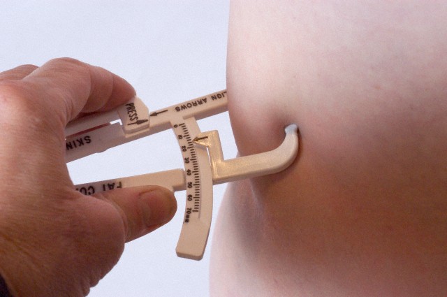 HHands using skin calipers to measure body fat