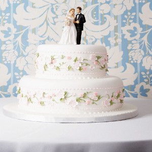 Wedding Cake with Bride and Groom Figurines --- Image by © Greg Hinsdale/Corbis