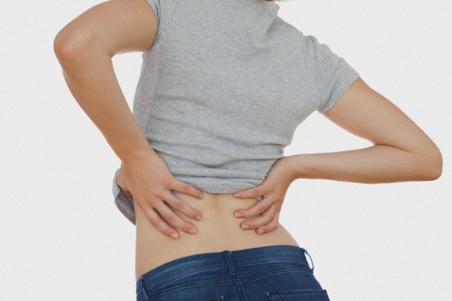 Rear view of woman with backache